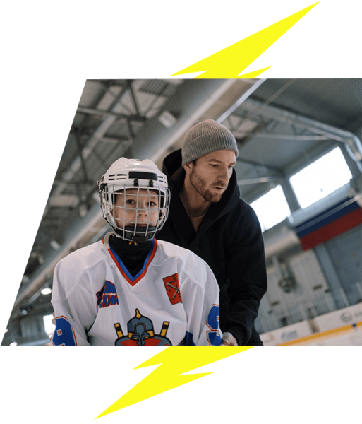 VI Storm Athletics coach working with kids hockey player on the ice
