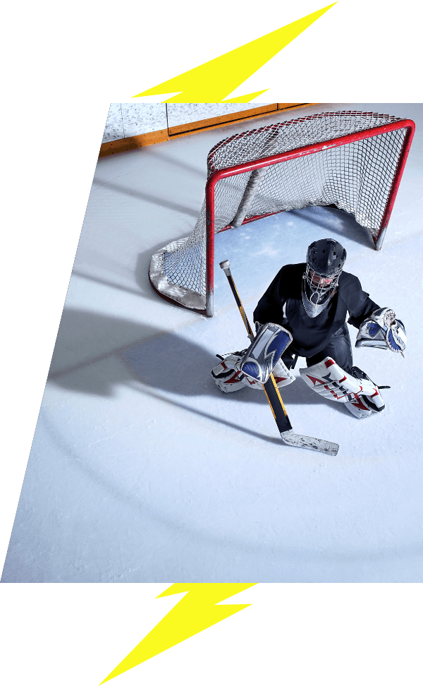 Young goaltender in net on the ice with lightning bolt image accents