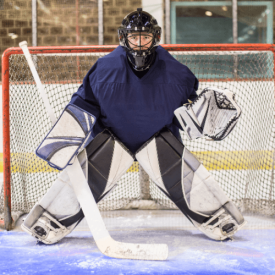 Kids hockey player posing for the camera on the ice